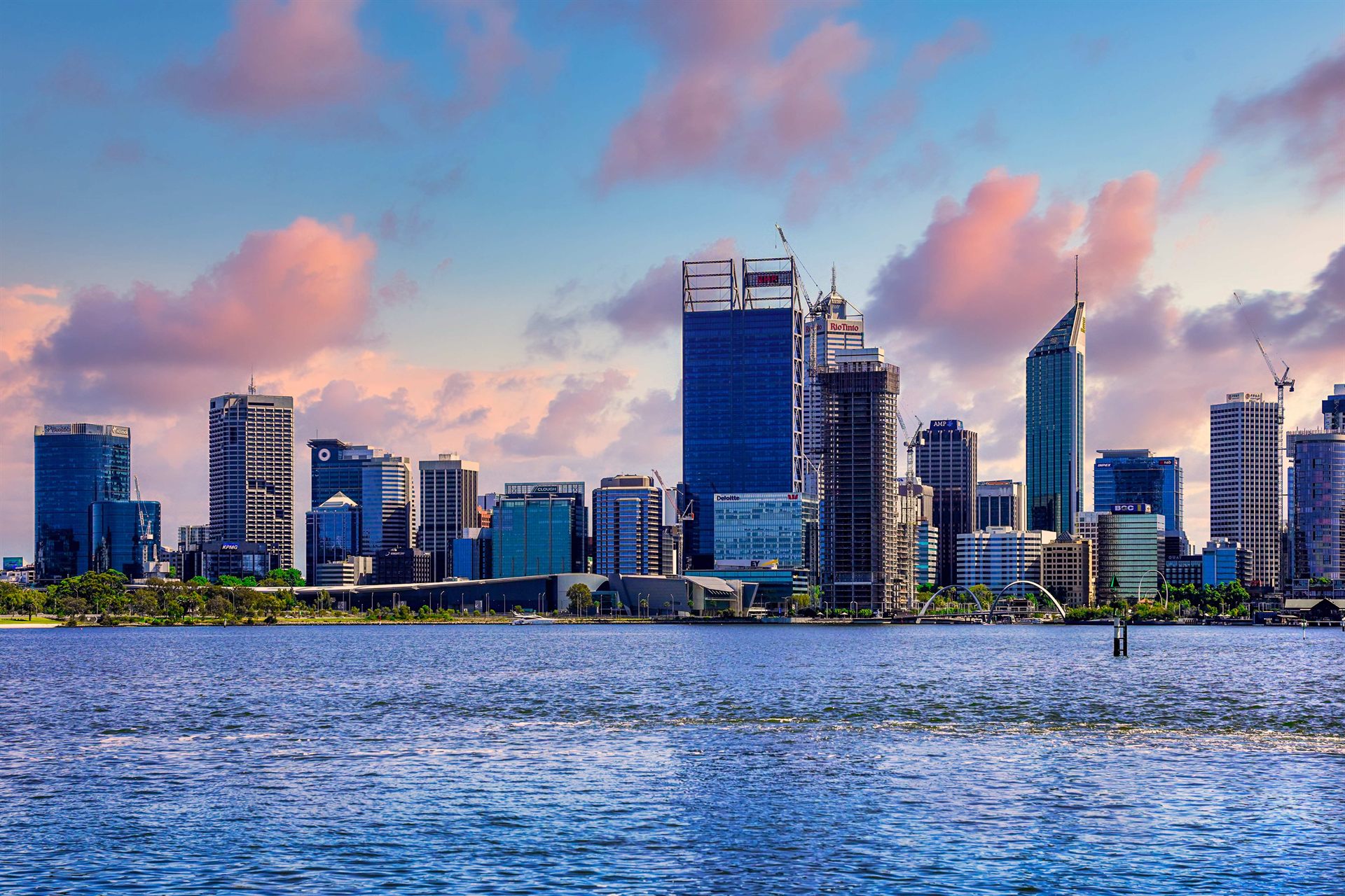 The Perth city skyline at dusk, seen across the Swan River