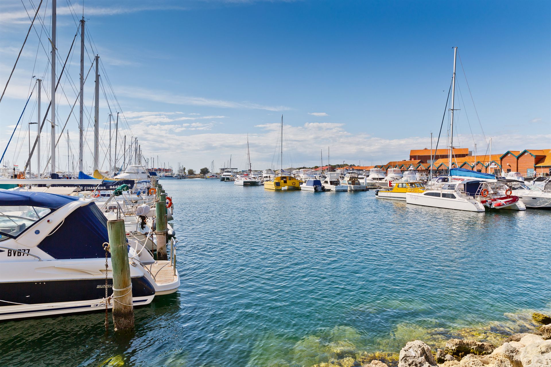 Boats moored at Hillarys Boat Harbour on a clear day
