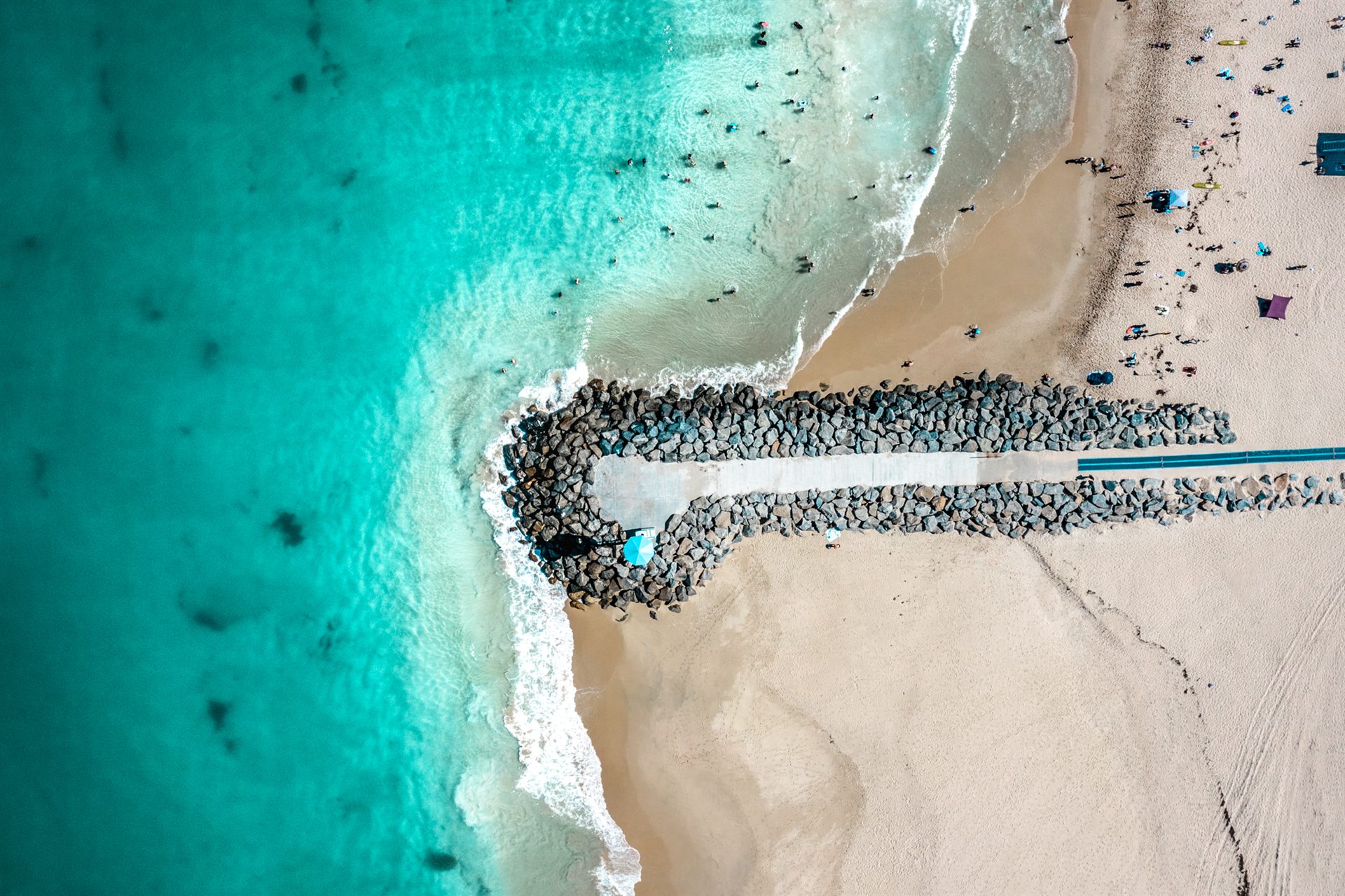 Aerial view of a Perth beach groyne and turquoise Indian Ocean water